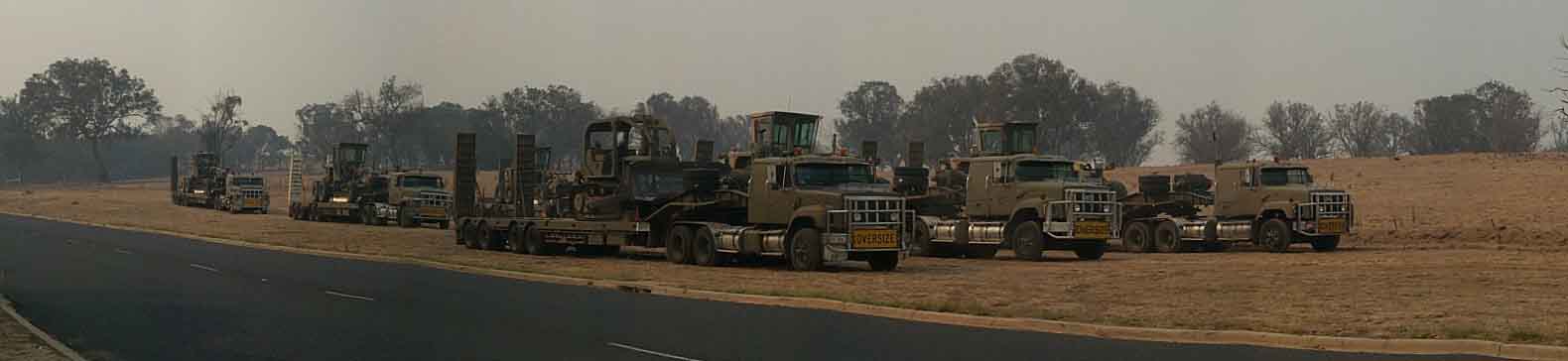 Army graders getting ready on their low loaders at Drake Brockman rural fire station